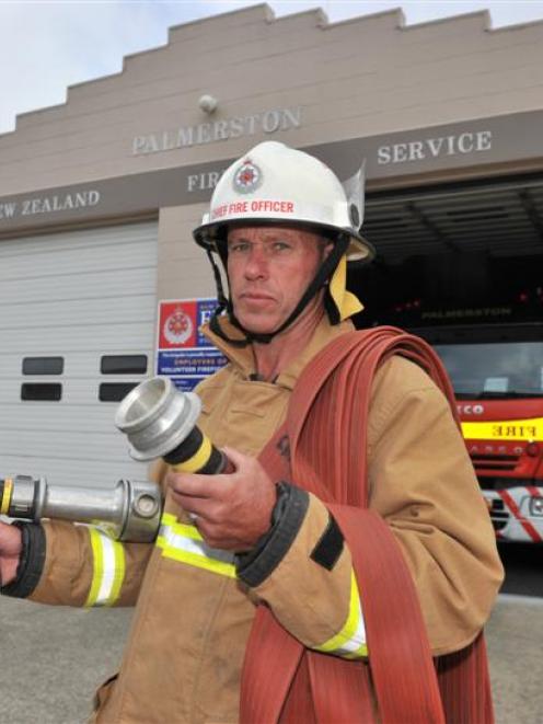 Palmerston Volunteer Fire Brigade chief fire officer Gary Johnston holds a dry fire hose.  Photo...