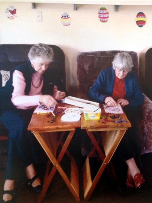 Pam Gale (left) and Gwen Staynes work on their Easter craft at the Mosgiel Elderly Care Trust...
