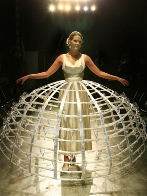 Pamela Hodges models the Moet and Chandon Pomponne dress covered in 100 Champagne flutes which...