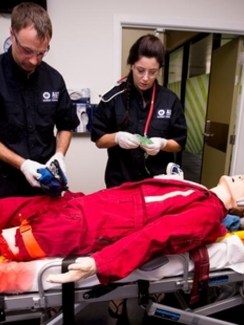 Paramedicine students (from left) Simon Watts, Stephanie Barrell and Junior Sione work on a dummy...