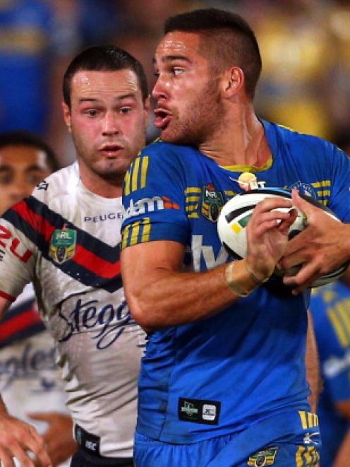 Parramatta's Corey Norman tries to outrun the Roosters defence. Photo Getty Images
