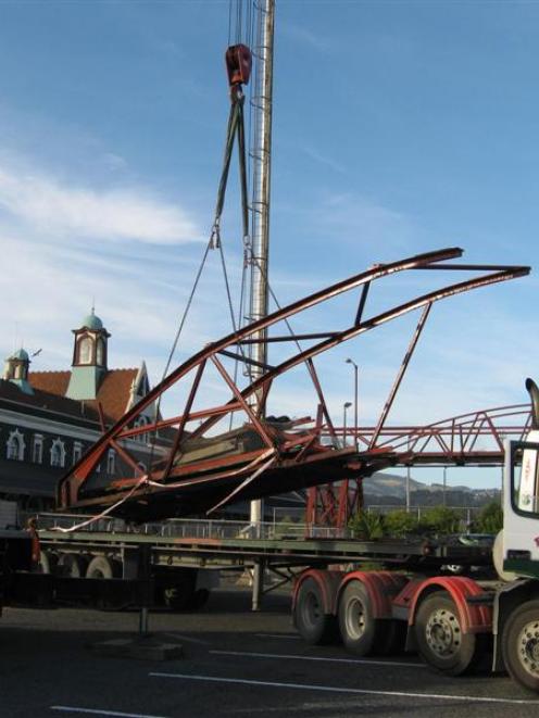 Part of the demolished Dunedin Railway Station footbridge is loaded to be carted away after it...