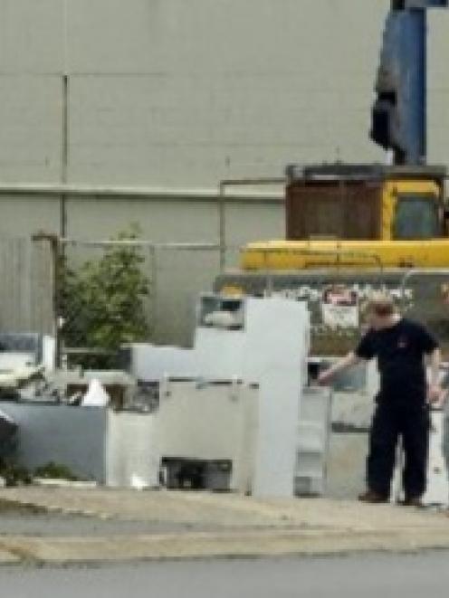 Passers-by check out whiteware dumped outside Sims Pacific Metals, on Wharf St, yesterday. Photo...