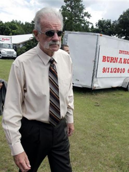 Pastor Terry Jones, right,  of the Dove World Outreach Centre arrives at a news conference in...