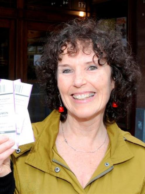 Paul Simon fan Maggie Hanton, of Dunedin, leaves the Regent Theatre with her concert tickets...