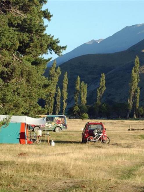 Peak time at the St Bathans domain campsite, with Central Otago's highest peak, Mt St Bathans ...
