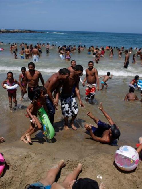 People at a crowded beach in Maiquetia on the outskirts of Caracas. Venezuelans began a week-long...