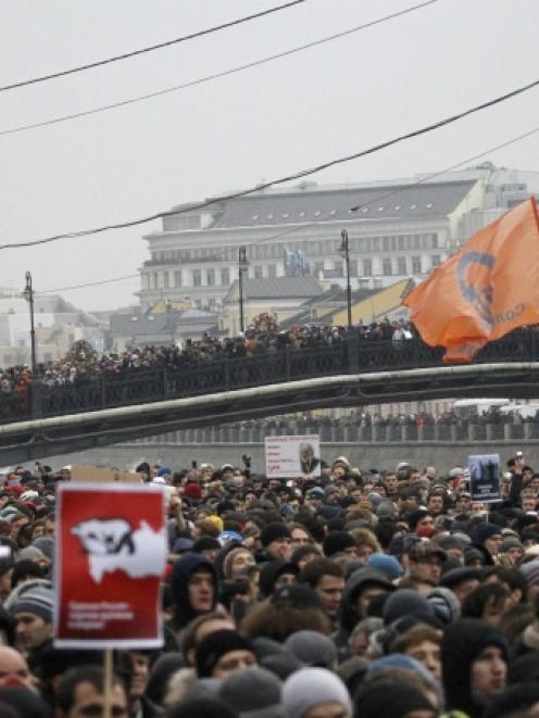 People attend a rally in Bolotnaya square to protest against violations at the parliamentary...