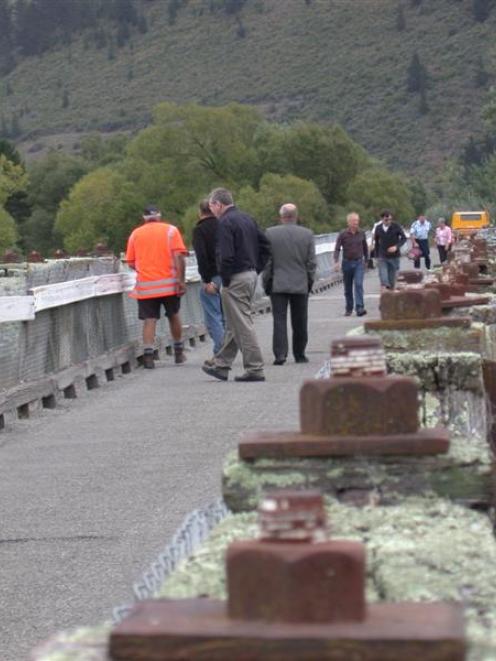 People cross and inspect the north bridge of the twin bridges across the Waitaki River at Kurow,...