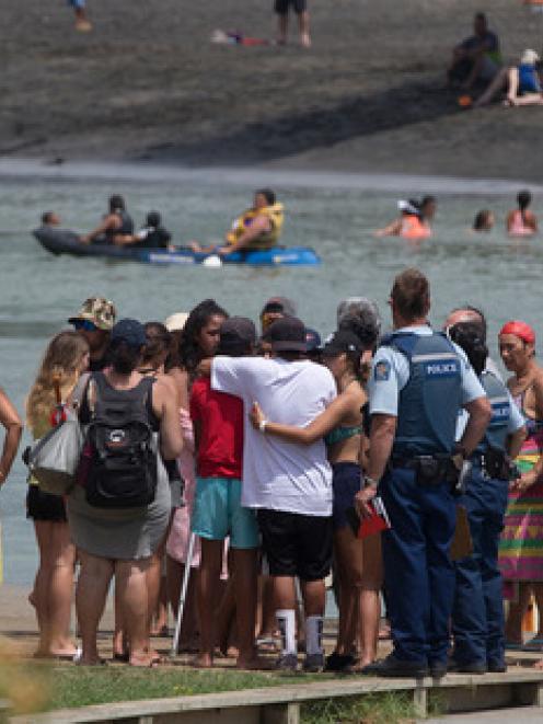 People gather opposite the footbridge from which the Raglan 16-year-old jumped. Photo: NZ Herald