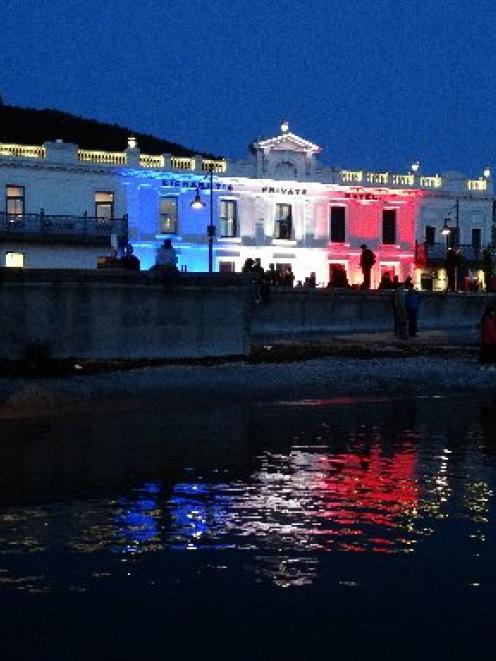 People gather outside Eichardt's Private Hotel on Queenstown's waterfront last night. Photo by...