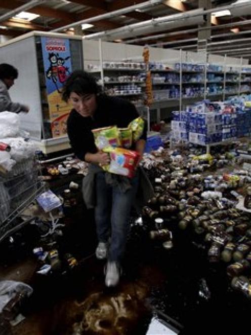 People loot a supermarket in Concepcion, Chile after an 8.8 magnitude earthquake. (AP Photo/...