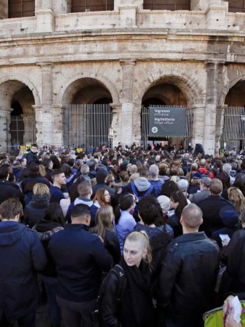 People queue to enter the Colosseum in Rome. REUTERS/Max Rossi