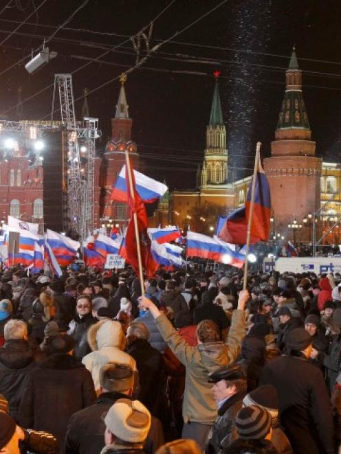 People rally in support of Russia's Prime Minister and presidential candidate Vladimir Putin in...