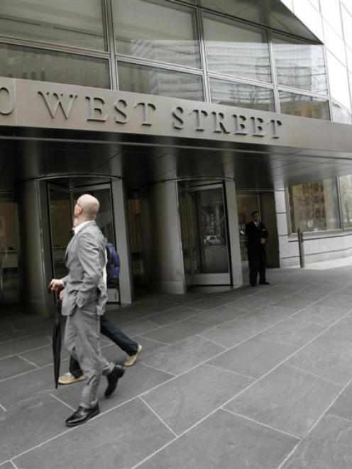 People walk past the Lower Manhattan headquarters of Goldman Sachs.