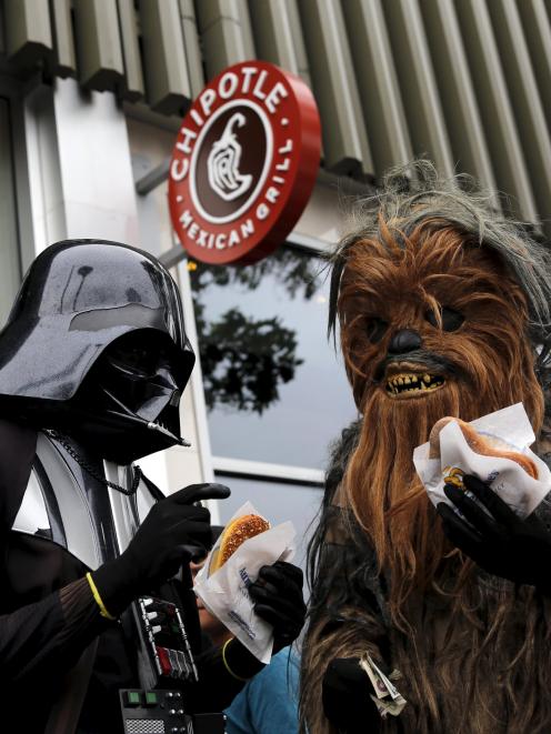 People wearing Star Wars-themed costumes eat pretzels in San Francisco. Photo by Reuters.