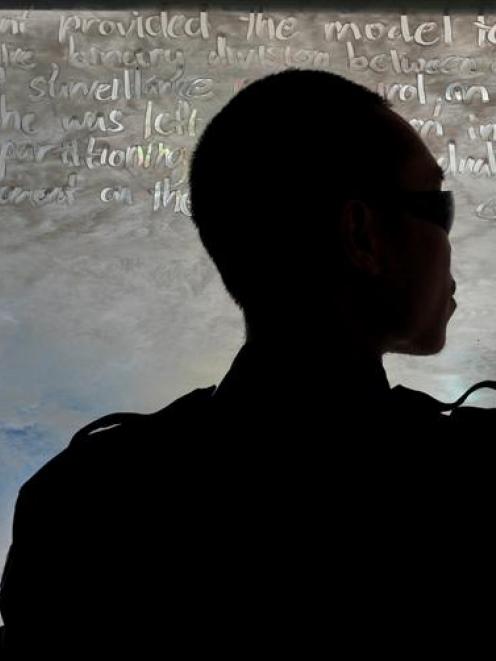 Performance artist Samin Son, of South Korea, transcribes words from Michel Foucault's book...