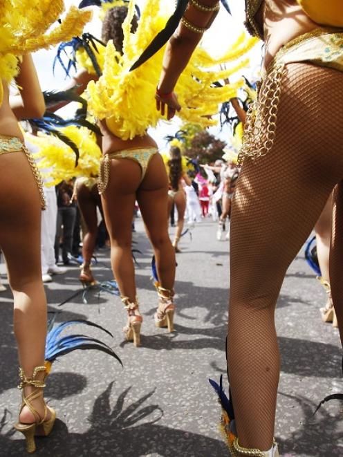 Performers dance in the street parade at the annual Notting Hill Carnival in central London....