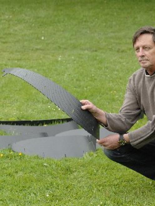 Peter Dunn demonstrates Soil Cell, a system he helped develop that helps with establishing...