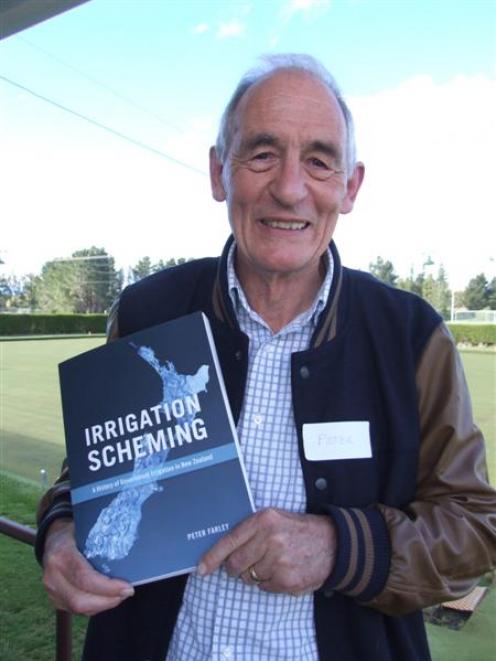 Peter Farley with his newly-launched book, <i>Irrigation Scheming</i>, at the Patearoa Bowling...