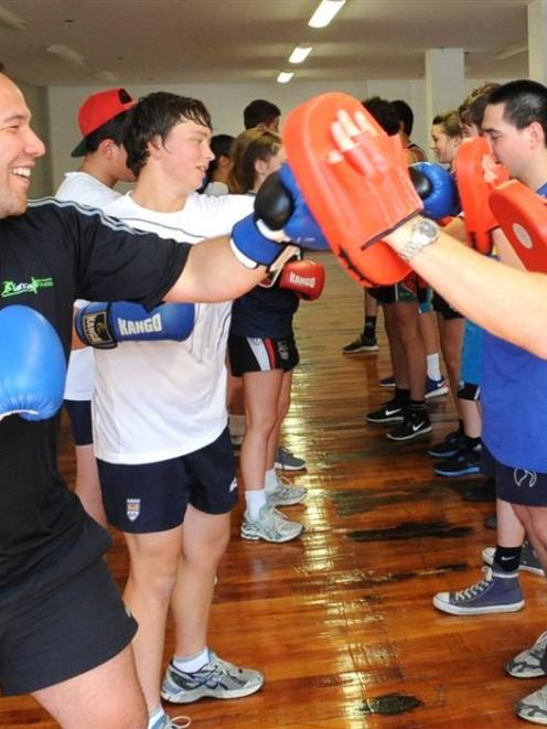 Peter Mirrielees (left) and Eben Joubert show some fitness techniques with a group of school...