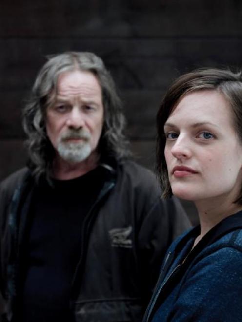 Peter Mullan, as crime lord Matt Mitcham, and Elizabeth Moss, as Detective Robin Givens, star in...