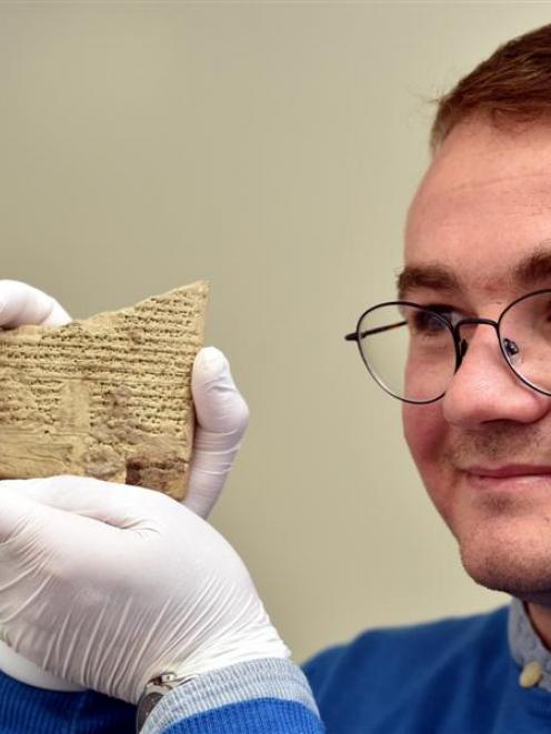 Peter Zilberg, a PhD student from the Hebrew University of Jerusalem, holds a 2500 year old clay...