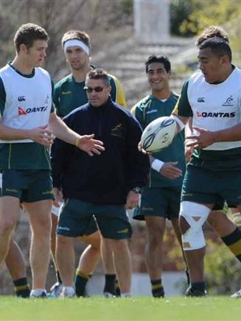 Phil Kite (centre) passes the ball to team-mate Lindsay Crook as skills coach Andy Clark (wearing...