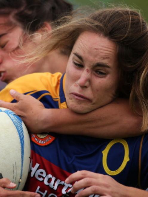 Phillipa Symes of Otago is caught by a Manawatu tackler. Photo Getty Images