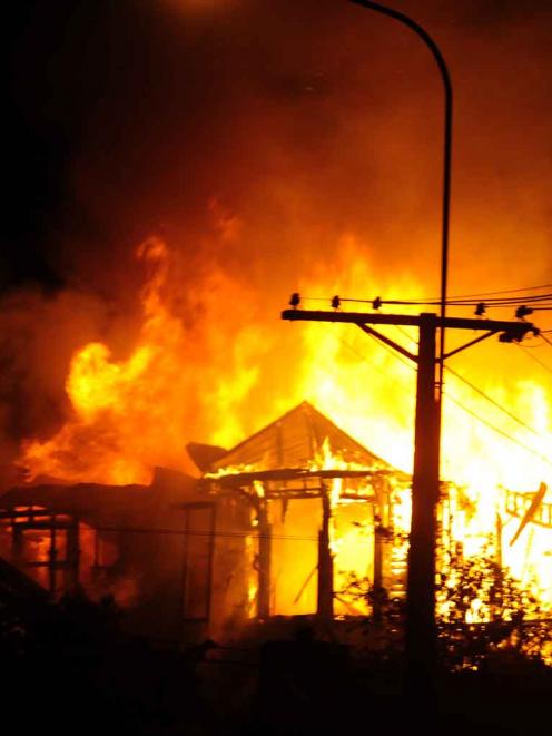 A Pine Hill Rd house fully engulfed in fire at 10.30pm on Saturday night. Photo: Craig Baxter.
