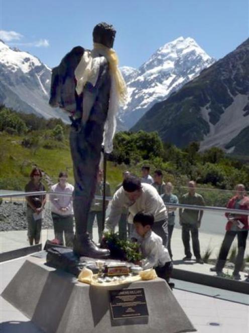 Phurenje and Edmund Sherpa lay a wreath at the base of a statue of Sir Edmund Hillary at Aoraki...