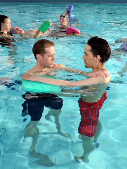 Physiotherapist Mark Shirley (left) helps client Christopher Matahaere in the physio pool, while...