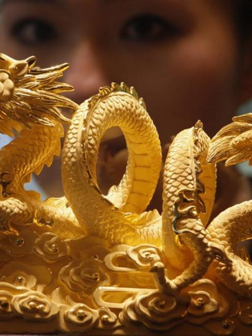 Pictured is a nine-tael 24-carat golden dragon, forming the numerals 2012, in a Hong Kong...