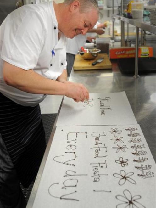 Pier 24 executive chef Michael Coughlin demonstrates piping chocolate, in preparation for the Fun...