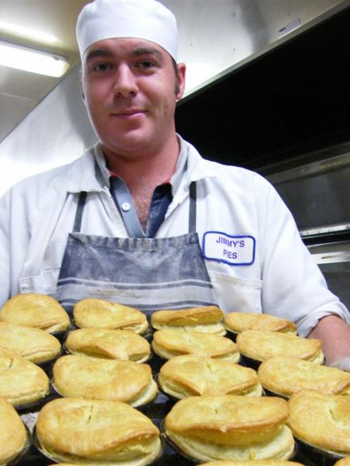 Pastry chef Bernard Kirkpatrick, of Roxburgh, takes another tray of pies out of the oven at Jimmy...