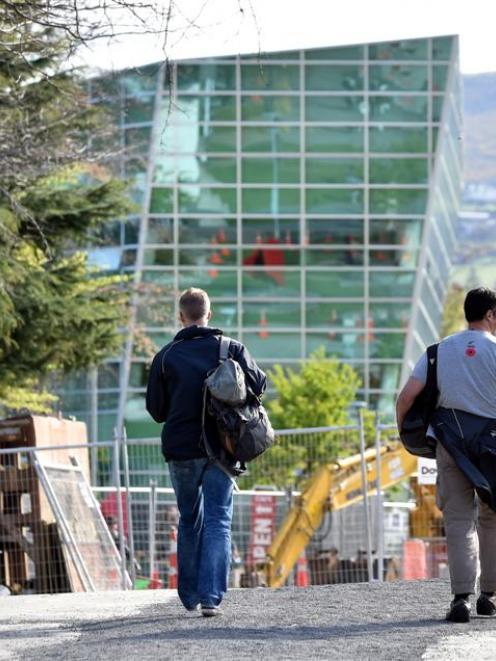Plain-clothed police monitor the University of Otago yesterday after a shooting threat. Photo by...