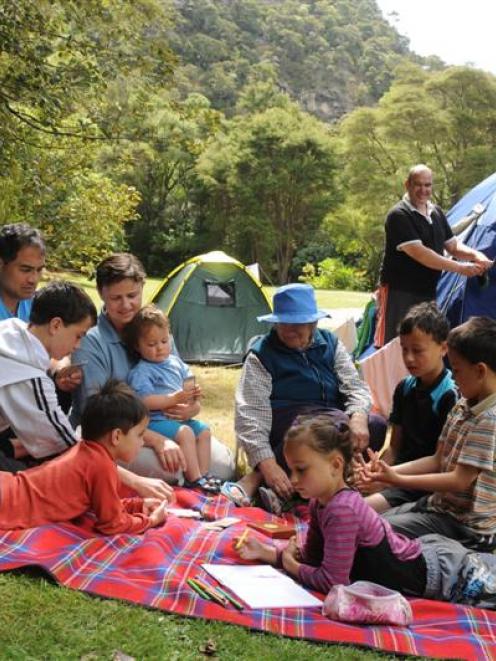 Playing cards at the Trotters Gorge Doc camp site are the Newton family (clockwise, from front...