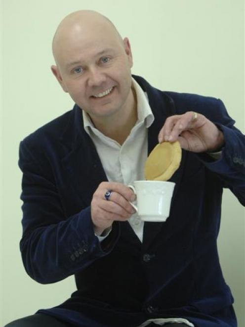 Playwright Andrew Cook demonstrates a "cup of tea and a biscuit" situation. Photo by Linda...