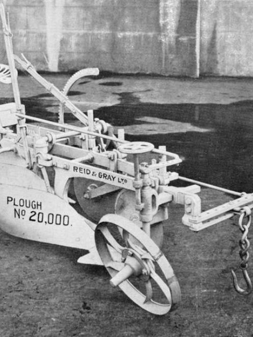 Plough number 20,000, a three furrow implement with self-lifting gear and driver's seat, produced...
