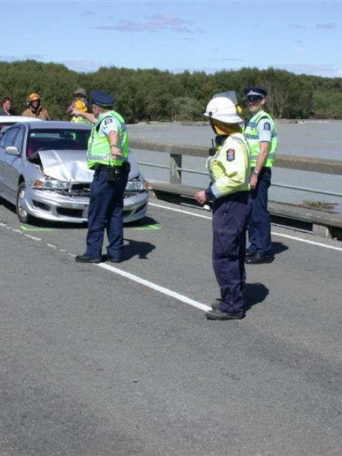 Police and emergency services attend a nose-to-tail crash involving four vehicles, from the white...