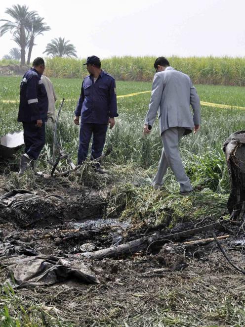 Police and rescue officials check the wreckage of a hot air balloon that crashed in Luxor. ...