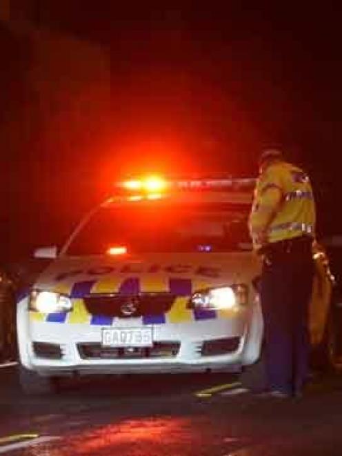 Police at the scene in Waldronville tonight. Photo ODT