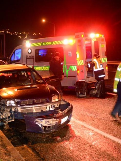 Police at the scene of a car crash on Dunedin's Southern Motorway last night.