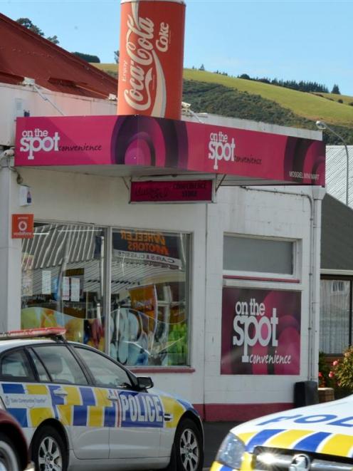 Police at the scene of an armed robbery at a  Gordon Rd, Mosgiel, dairy yesterday morning. Photo...