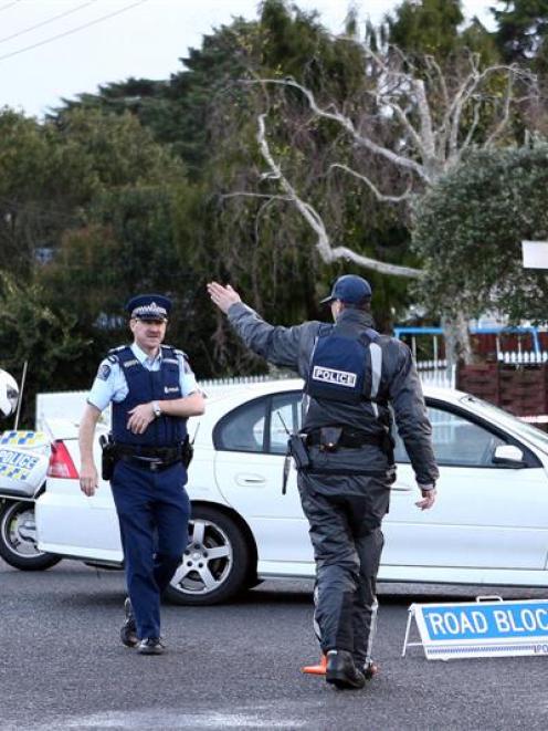 Police block the road where a police officer was shot dead and another injured in Mangere. Photo...