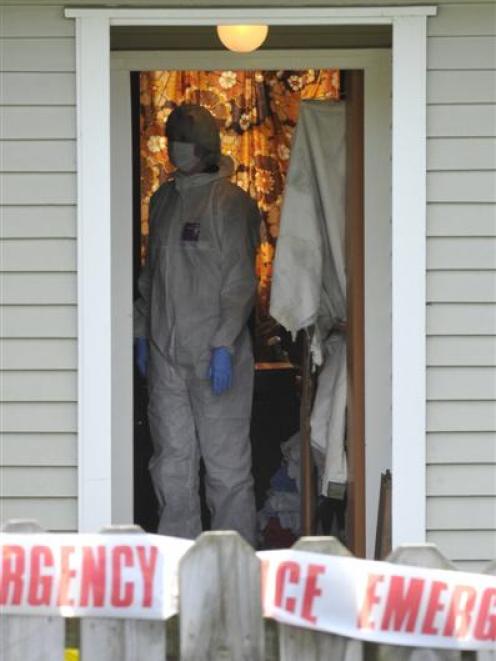 Police conduct a forensic examination of a house in Gilmerton St, Corstorphine, as part of a...