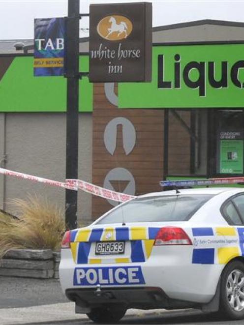 Police cordon off an area after an armed robbery at the White Horse Inn in Milton yesterday....