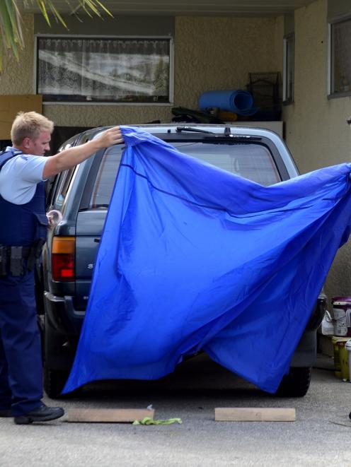 Police cover the Toyota 4WD involved in the alleged abduction of a 2-year-old Dunedin girl from...
