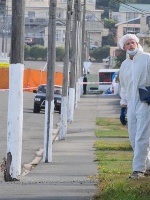 Police forensic staff yesterday search Exe St, Oamaru, properties for the weapon used in a fatal...