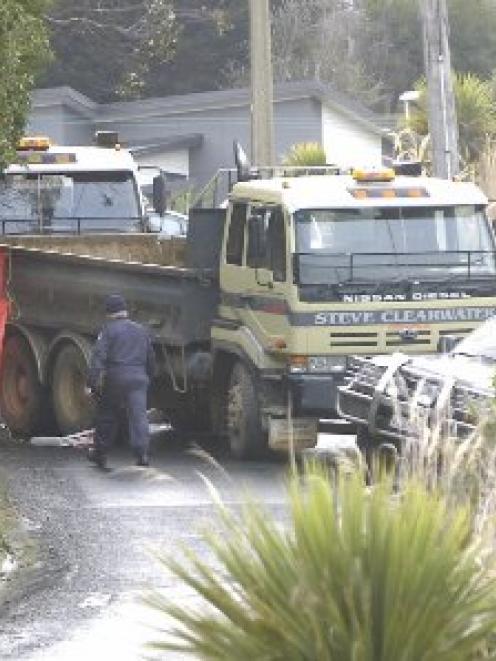 Police inspect the scene of a collision between two heavy earthmoving trucks on Luss Rd, Company...